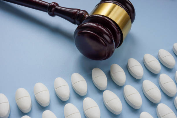istock Medical pills and a gavel. Pharmaceutical violations. 2191071816
