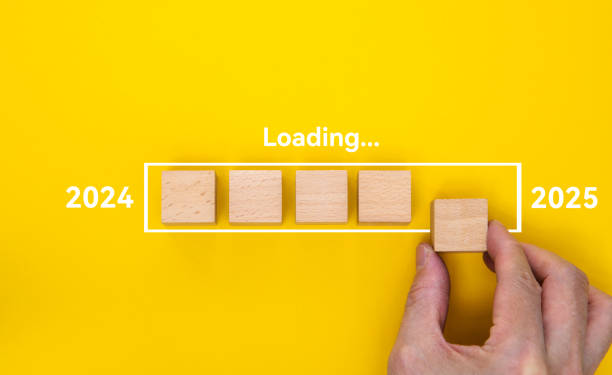 istock Loading new year 2025 with hand putting wood cube in progress bar 2191072320