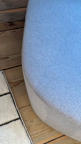 istock Grey sofa on the wooden floor 2191072771