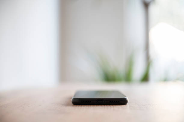 istock Minimalist smartphone on wooden surface 2191081858