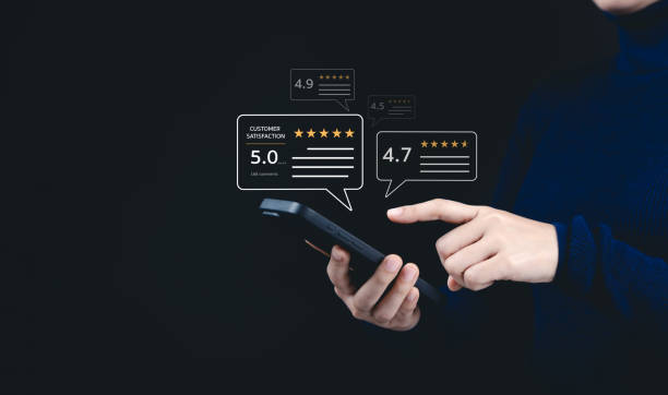 istock Customer review satisfaction feedback survey concept. A woman interacts with a smartphone, giving a five-star rating using a digital feedback system, positive customer satisfaction and feedback. 2191081881
