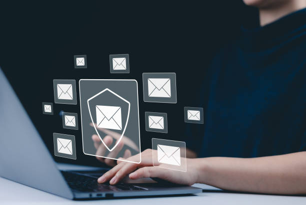 istock Email security and protection technology concept. A woman using a laptop and phone, with virtual email icons and shield symbolizing data security and communication protection. cybersecurity threats, 2191081909