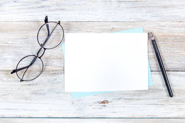 istock Blank White Card Mockup on Wooden Background 2191081983