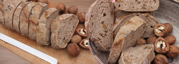 istock Sliced ​​walnut bread on a wooden cutting board 2191083683