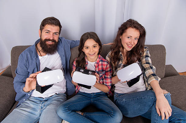 mom dad and daughter. digital future and innovation. modern life. father mother and child wireless VR glasses. virtual reality family. happy parents with teen girl use modern technology.