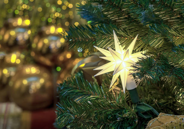 istock Pointed Herrnhut star with LED lights on the Christmas tree. 2191086602