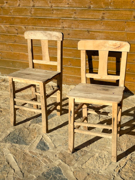 istock Wooden chairs in garden with sunlight and shadow 2191086752