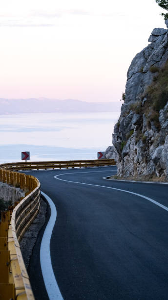 istock View up curving highway in rugged landscape 2191087561