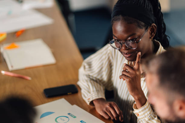 istock Focused marketing professional analyzing charts during team meeting 2191092681