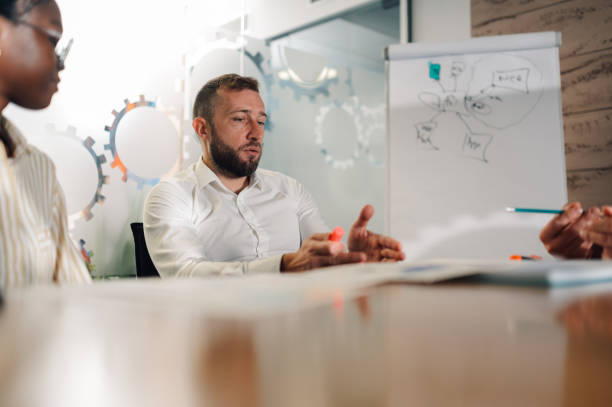 istock Business team analyzing charts and reports during meeting in modern office 2191092682