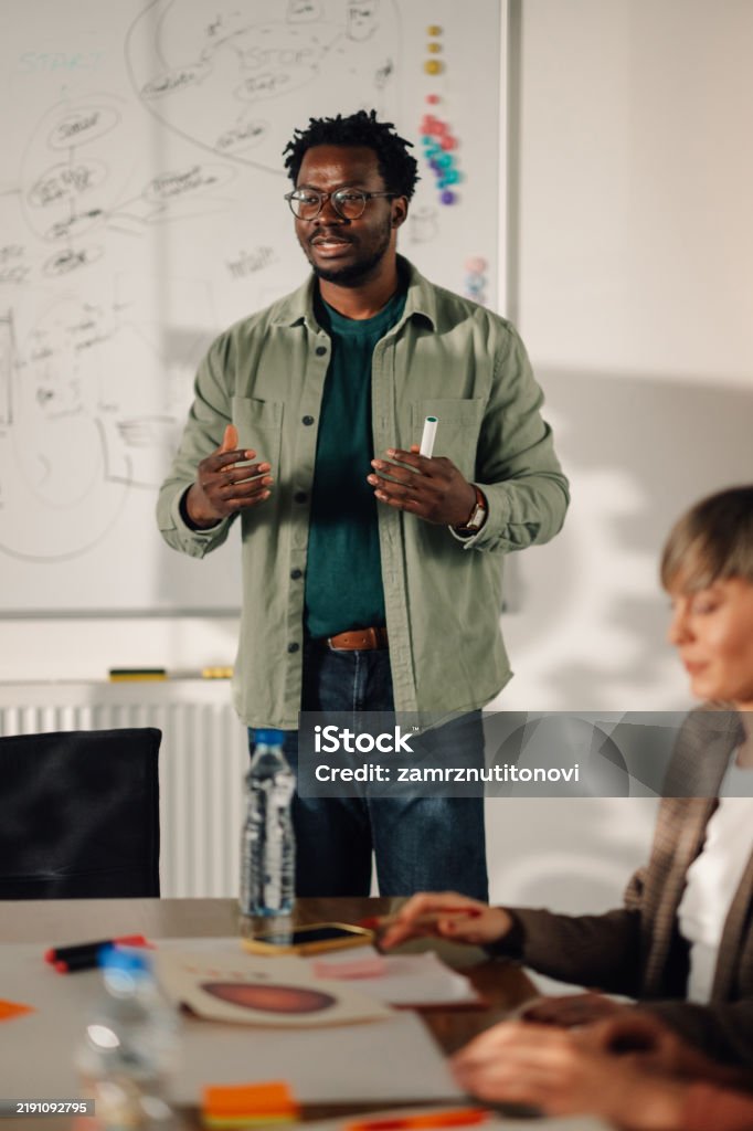 Prof Explaining Image Young Professor Explaining Lesson To Students In Classroom Stock Photo ...