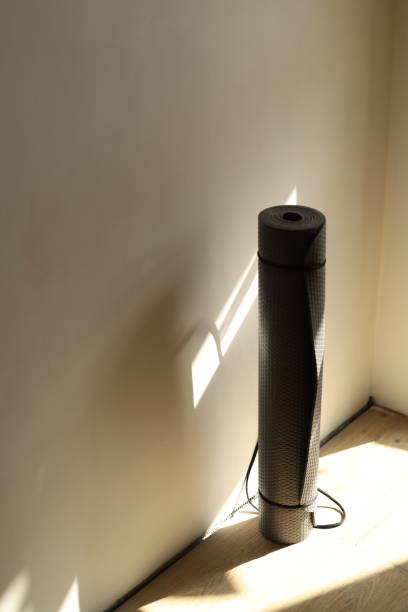 istock gray folded yoga mat against the wall, top view 2191097025