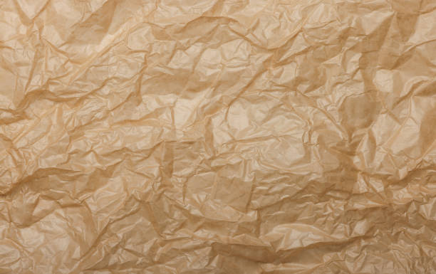 istock Crumpled brown baking paper creating a textured background 2191097823