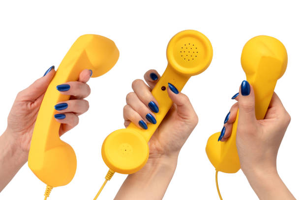 istock Yellow handset in woman hand isolated on white. Copy space. 2191098153