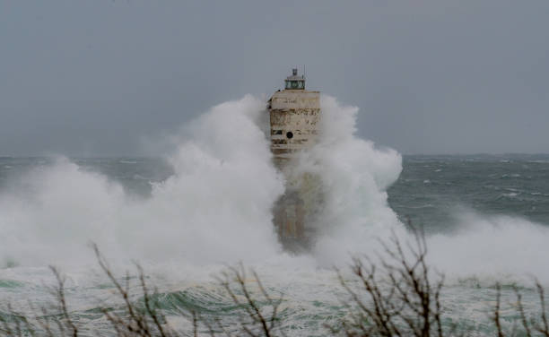 istock Stormy sea waves crashing against Mangiabarche lighthouse during hurricane 2191099016