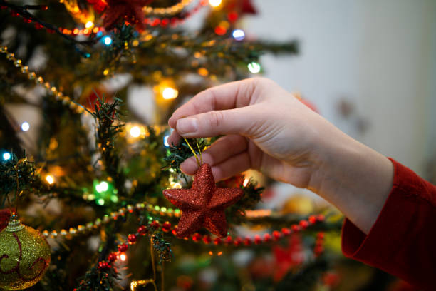 istock Close up of woman's hands decorating christmas tree 2191102400