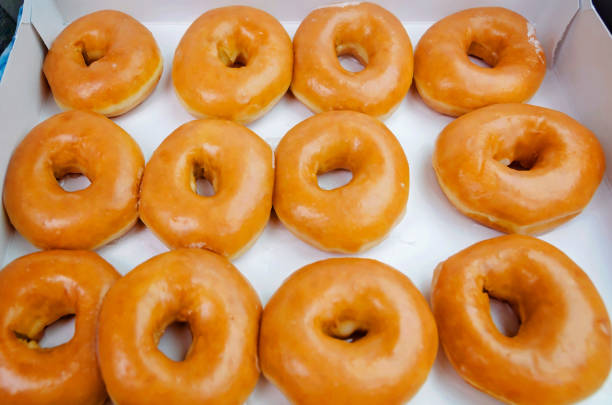 istock Dozen glazed doughnuts in a box in Ocean Springs Mississippi 2191105648