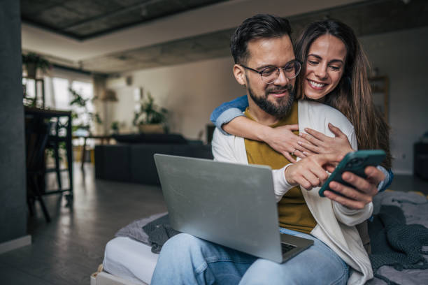 istock Happy couple looking at phone together 2191110162