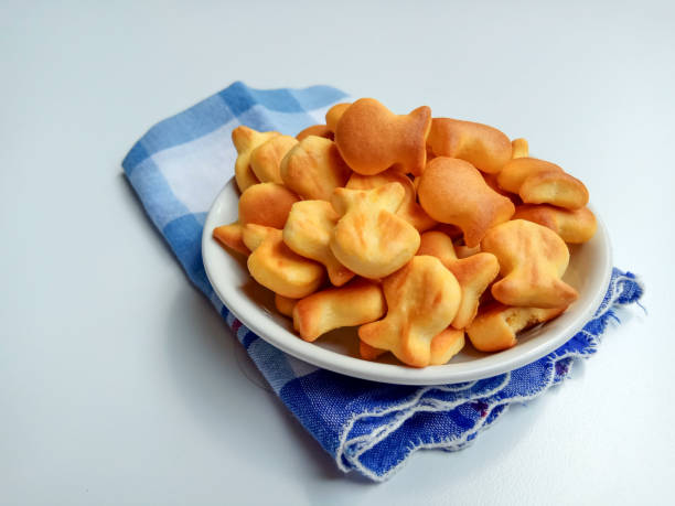 istock Salted crackers in fish shape in white bowl. 2191111417