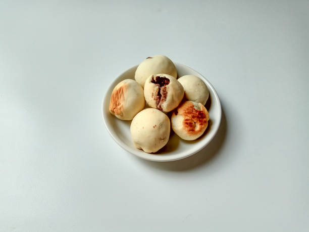 istock Nopia, is a traditional snack from Banyumas, Indonesia. Made from flour dough filled with red sugar, baked in a furnace. Isolated on white background. 2191111476