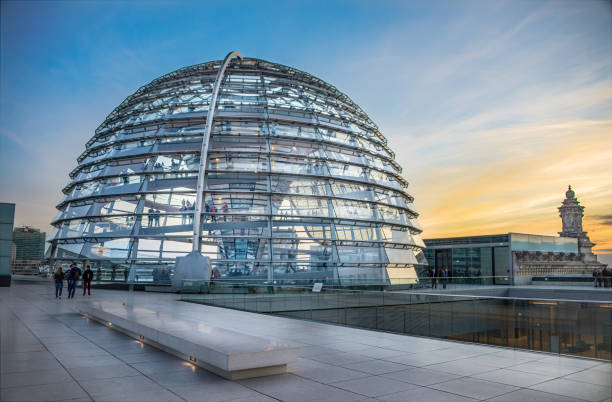 Berlin, Germany - September 1, 2015 - A photo of the glass Reichstag Dome, located on top of the Reichstag building in Berlin, Germany, gives visitors a 360º view of the surrounding area and a sunset on the horizon.