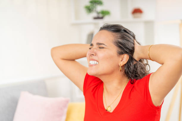 istock Young woman suffering from strong headache at home 2191114156