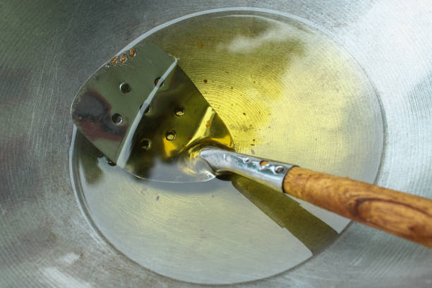 cooking oil with a spatula in a frying pan