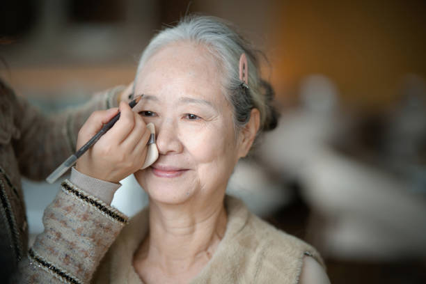 istock Asian elderly woman putting makeup before a party 2191118692