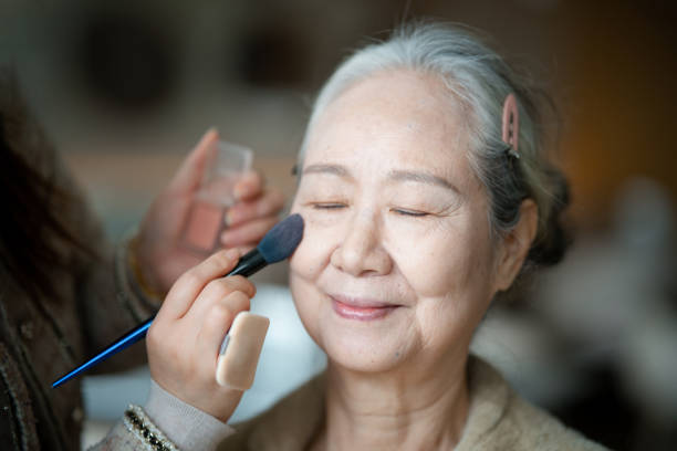 istock Asian elderly woman putting makeup before a party 2191118732