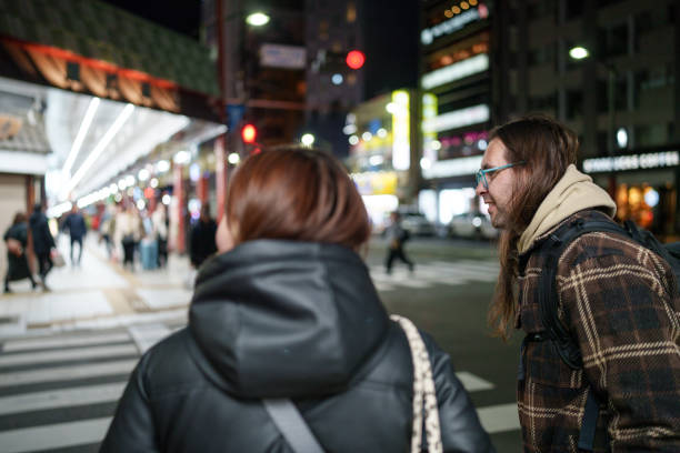 istock Couple waiting at the traffic light at pedestrian walkway. 2191119862