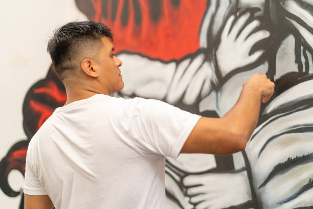 istock Street artist designing a graffiti mural on a building wall 2191120120