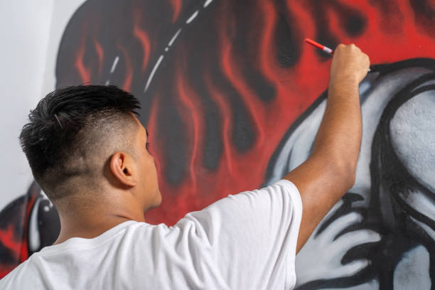 istock Young artist designing a vibrant mural on a wall 2191120171
