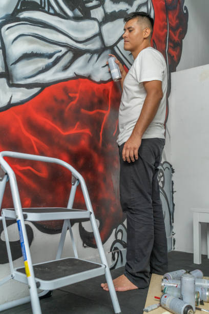 istock Artist carefully painting a mural on a wall 2191120200