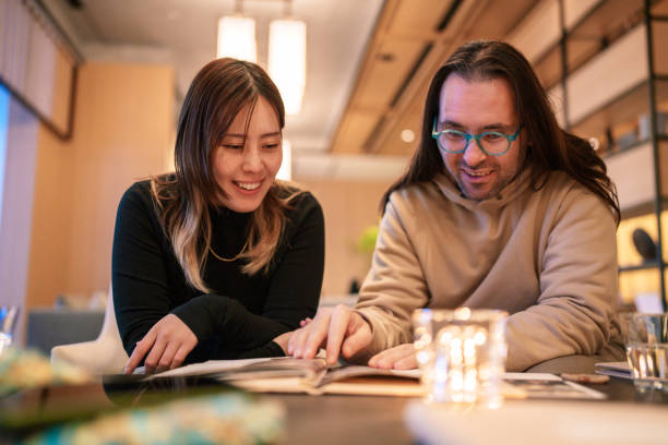 istock Couple looking at the menu in a cafe. 2191120222
