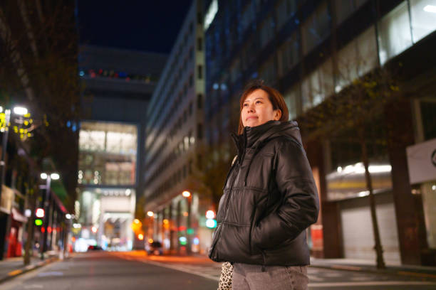 istock Woman walking on crosswalk in Tokyo. 2191121207