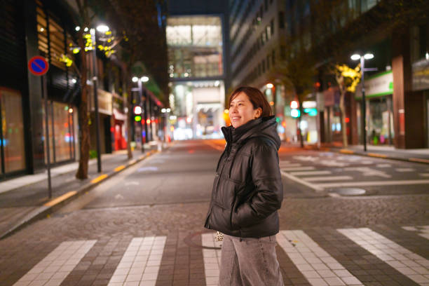 istock Woman walking on crosswalk in Tokyo. 2191121210