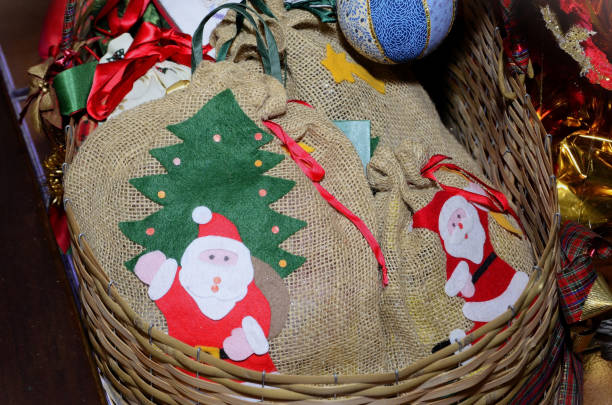 Jute gift bags basket with Santa Claus under the Christmas tree