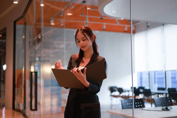 istock A Charming young Asian businesswoman using a digital tablet  and a smartphone online application for work  at the modern office and  Copy space 2191122161