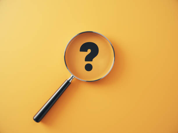 istock Question Mark Icon selected with metallic magnifying glass on yellow background. 2191122943