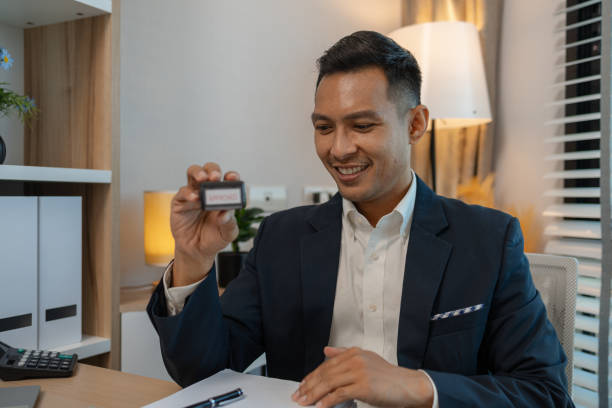istock stamped the document to approve, businessman professional working while sitting at office desk, accountant, marketing, employee is working alone in the office, approving report, 2191123161