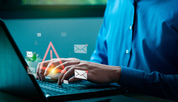istock Cybersecurity Email Threat Concept with Businessman Receiving Fraudulent Messages, Highlighting Spam, Phishing Attacks, and Online Data Security Risks on Laptop, viruses, junk mail, scams 2191123201