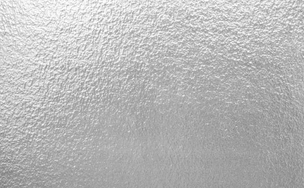 istock Grainy silver leaf bright aluminum foil texture tinfoil surface abstract gradient metallic monochrome seamless background 2191123319