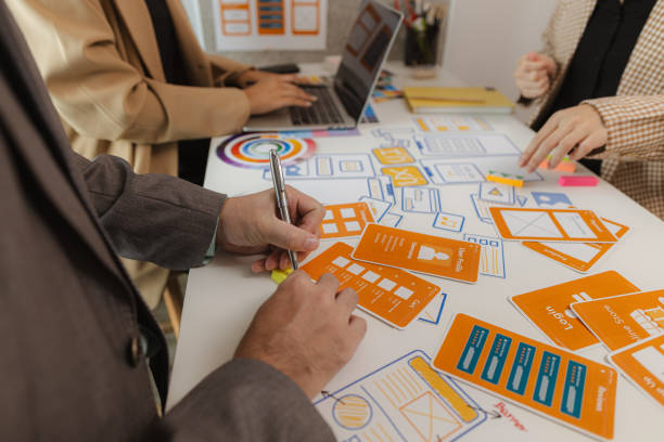 istock Digital product business owners brainstorm to find conclusions on choosing different website design styles that meet the needs of today's users who need to be easy to use and have a beautiful design. 2191123997