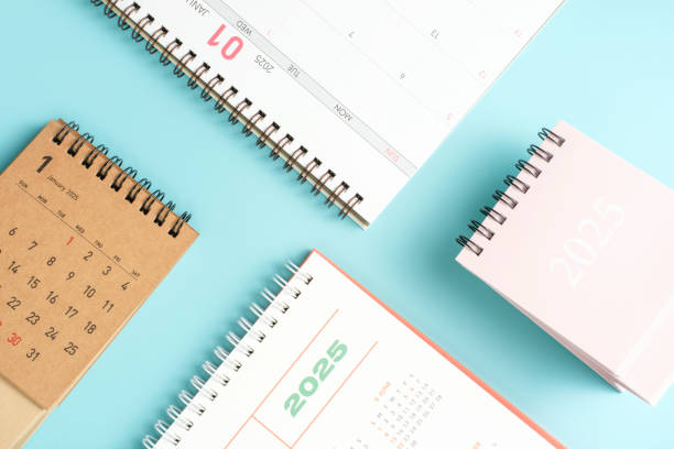 istock White and brown calendars on blue background top view close-up, planning concept. 2191124910