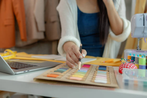 istock beautiful young lady tailor at work, beautiful female designer at design studio, crop view of fashion designer at work, woman in tailor workshop, clothing designer in workshop. 2191125593
