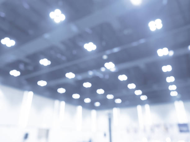 istock Abstract blur lighting decoration interior. Blurred convention hall construction building, ceiling spotlight soft unfocused. Blurry white auditorium background for advertising, business presentation. 2191129161