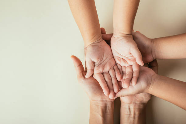 istock Parents and kid hold empty hands top view isolated. Commemorating Family Day expressing togetherness support and lineage. 2191129431