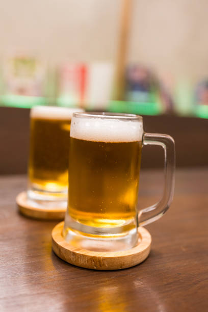istock Two glasses of beer on a wooden table 2191129496