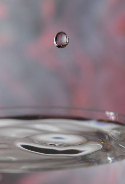 Wine dripping from bottle into glass