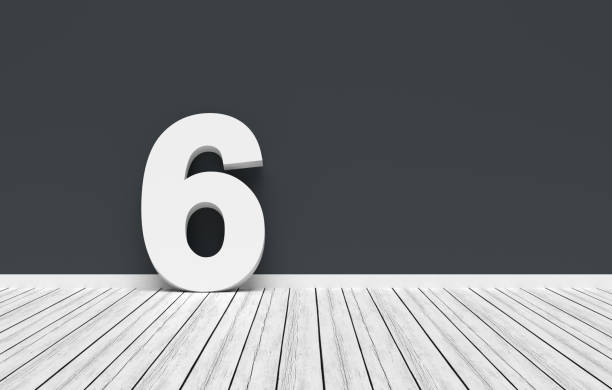 istock Number six leaning on dark gray wall in white room 2191134620